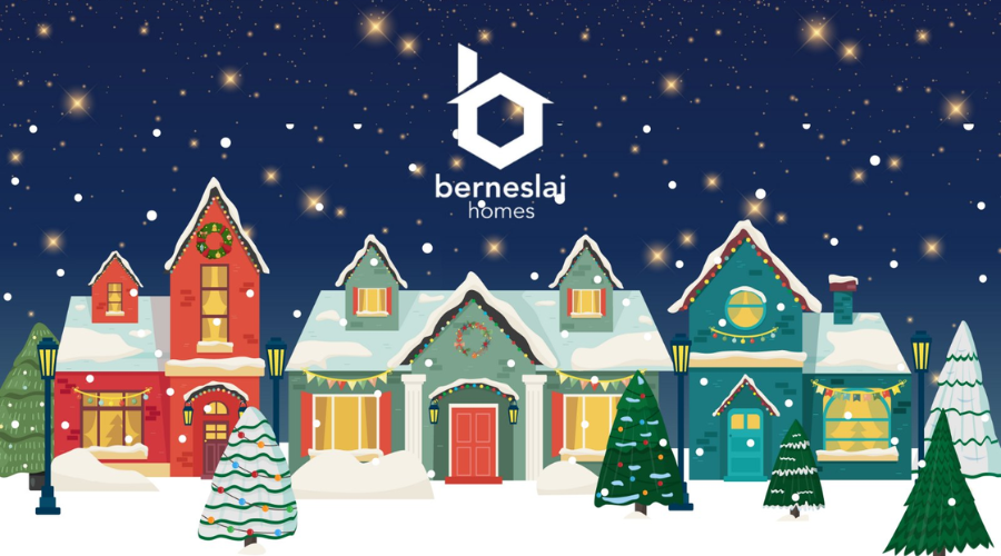 Christmas houses and trees on a street covered in snow