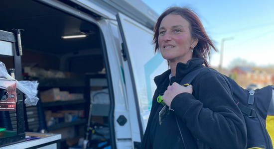 A gas apprentice stood next to a works van.