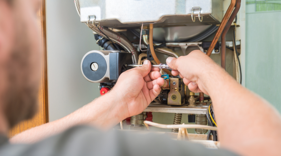 Gas Engineer Carrying Out An Annual Gas Safety Check