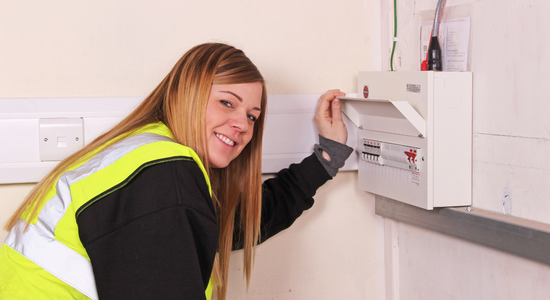 An electrician inspecting the trip switches.